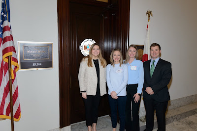 4 people standing in front of a door